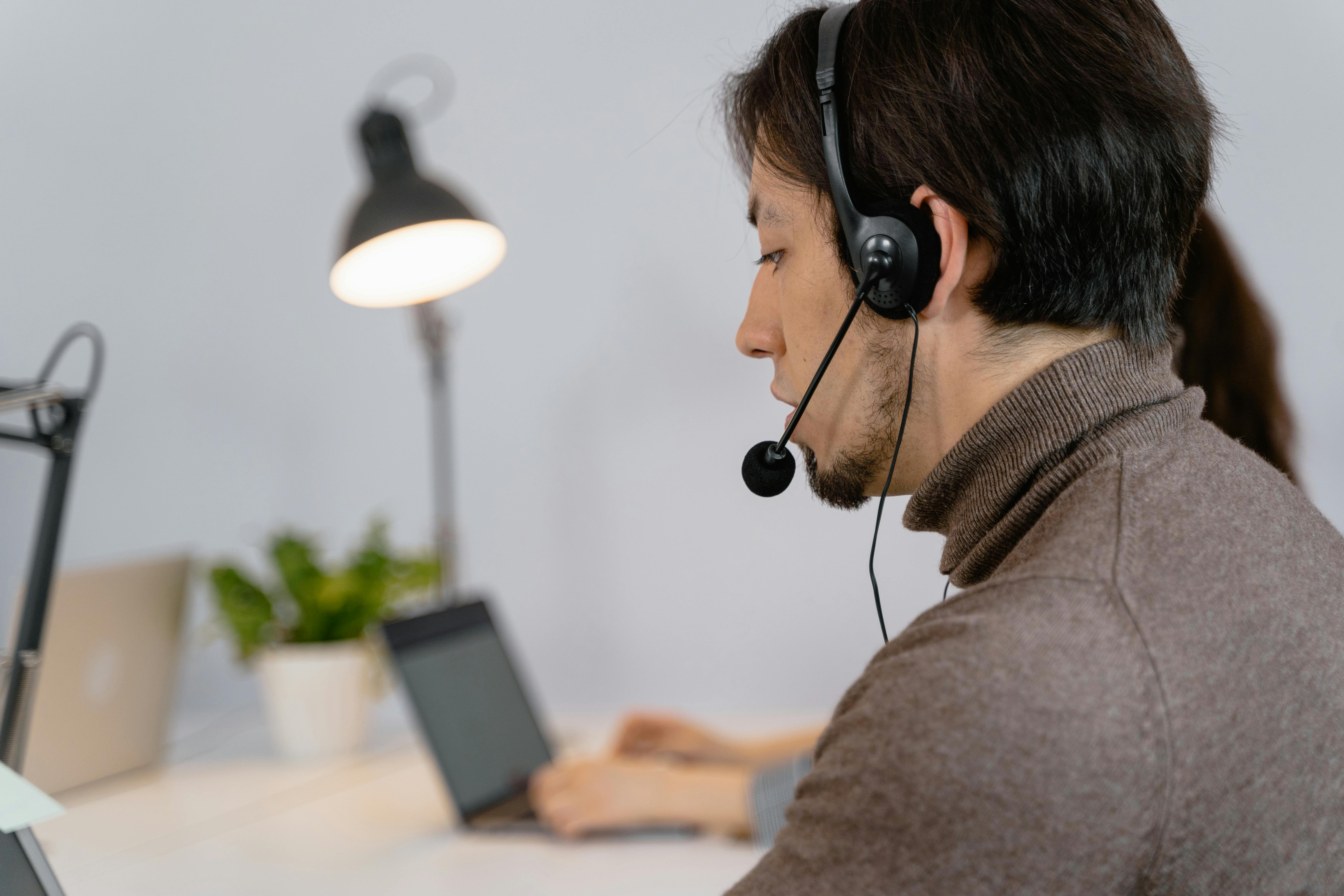 Professional IT helpdesk support representative with headset providing customer service
